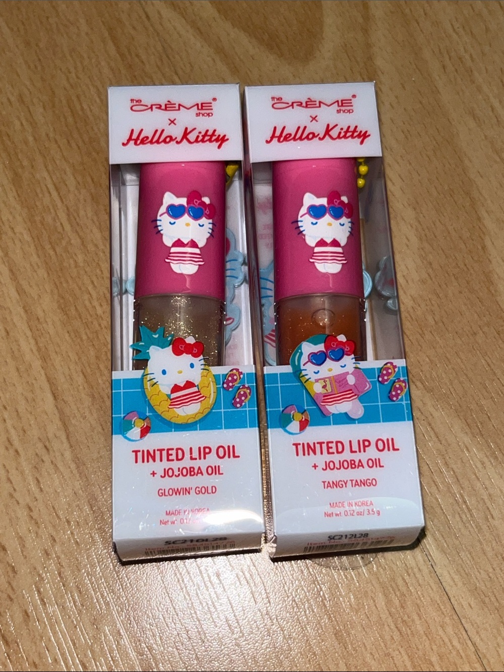 The Crème Shop x Hello Kitty Tinted Lip Oil set in Glowin Gold and Tangy Tango